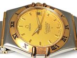a gold and silver watch with roman numerals on it