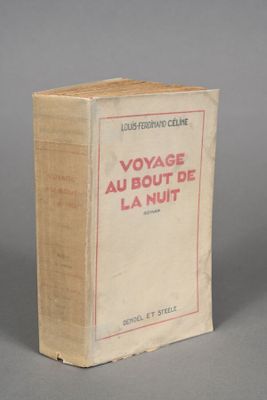an old book sitting on top of a table on a gray surface