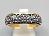 a gold and silver ring with black and white diamonds