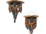 two wall sconces that are made of wood and decorated with animals