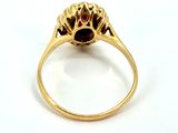 an image of a gold ring with a garnet stone in the center