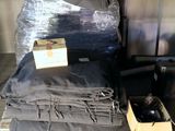 a pile of clothes and a box of bottles on a table