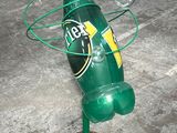 a green bottle that is on top of a gold coin