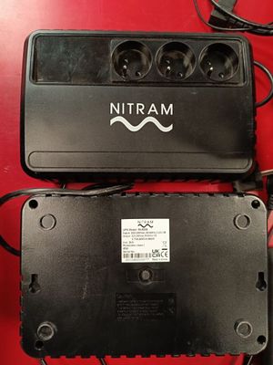 two black batteries are sitting next to each other on a red table