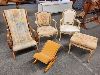 five chairs and a ottoman in the middle of a room