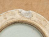 a close up of a white plate with a brown rim