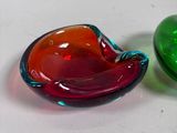 pair of colorful glass bowls sitting on top of a white surface