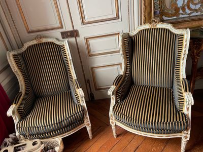 two chairs sitting next to each other on a hard wood floor