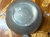 a silver pot sitting on top of a wooden table