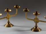 pair of antique brass candlesticks on a stand