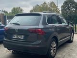 the back of a gray volkswagen suv parked in a parking lot
