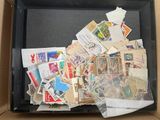 a box full of stamps and envelopes sitting on a table