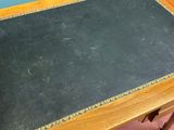 a small table with a black top and a wooden base