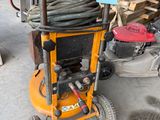 a small machine that is sitting in the garage