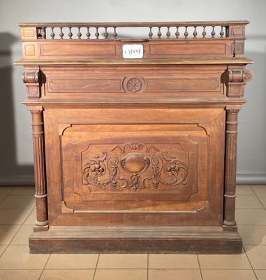 a wooden cabinet with carvings on it in a room