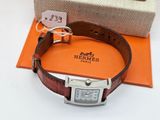 a watch that is sitting on a brown leather strap
