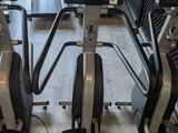 a row of tread machines in a gym room