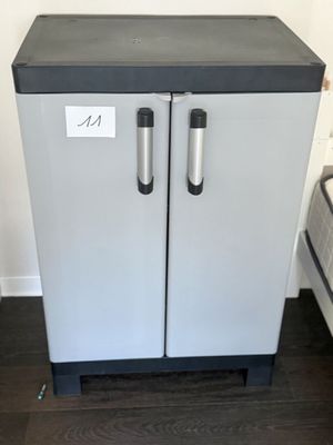 a refrigerator that has two doors and a sign on the door
