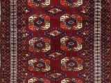 a red and blue rug with geometric design on a white background