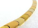 yellow gold plated necklace with a curved design on a white background