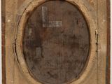 an old wooden frame with a picture of a man in a hat