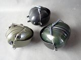 three small metal containers sitting on a white surface