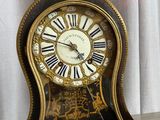 two clocks that are sitting next to each other on a table