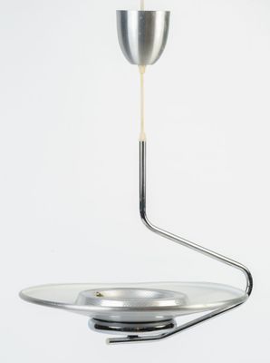 a spoon with a liquid pouring out of it on top of a plate