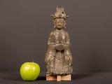 a statue of a woman with a crown next to an apple
