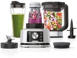 a blender with a green smoothie in it and a blender with a green smoothie in it