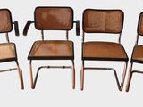 four chairs with cane backrests and cane backrests are arranged in a row