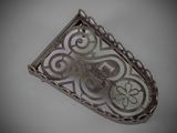 an image of a silver pendant with an intricate design on it