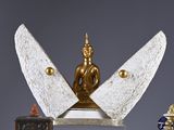 a statue of a buddha sitting on top of a table