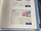 an open book with stamps on it sitting on a table