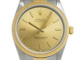 an image of a gold and silver rolex watch with roman numerals