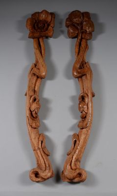 pair of carved wood candlesticks with flowers and leaves