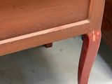 a wooden dresser with a drawer on top of it