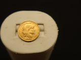 a gold coin sitting on top of a white object