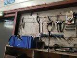 many tools hanging on the wall in the garage