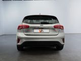 the rear end of a white ford focus parked in a showroom