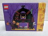 the box is open to show the contents of the lego haunted house