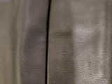the back of a black leather jacket with a zipper on it