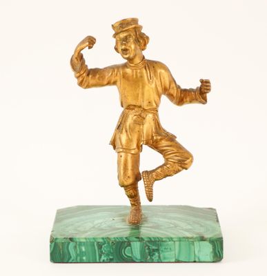 bronze figurine of a boy on a green marble base
