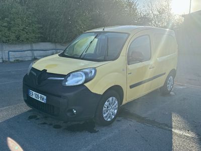 a small yellow van that is parked in a parking lot