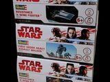 three star wars action figures are on display in a display case