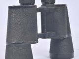two black binoculars that are sitting on a white surface