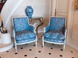 two chairs that are sitting in front of a staircase