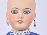 a doll that is wearing a blue dress with white lace on it