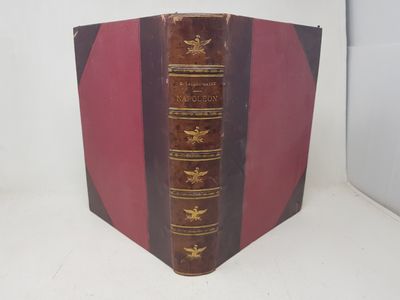 an old book sitting on top of a table next to a white wall