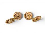 a pair of gold cufflinks on a white background